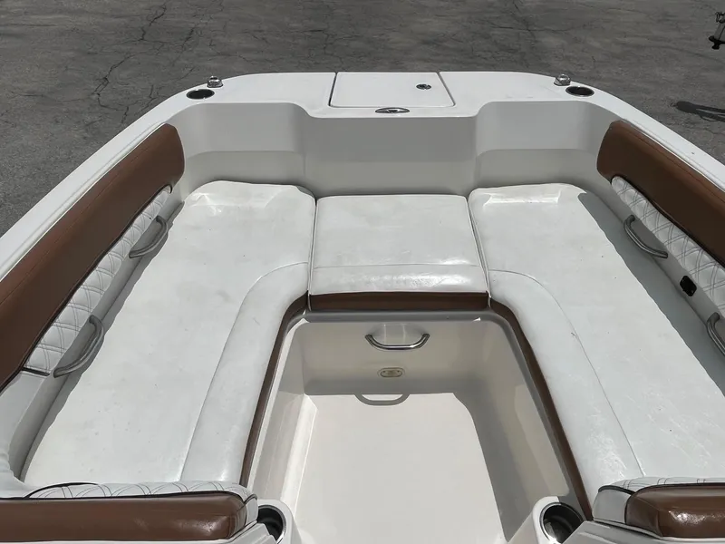 Slide: The Image of Bayliner DX 2200 2022 boat interior with white and brown seating, spacious layout. - 10