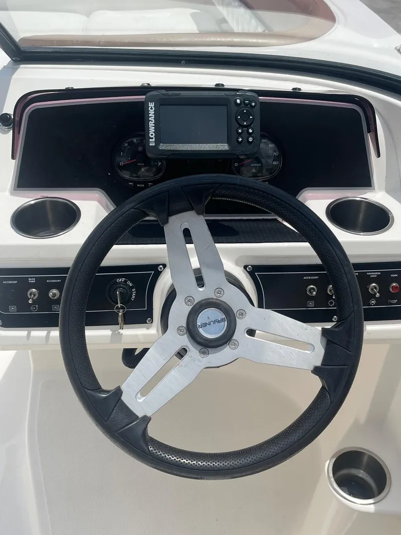 Slide: The Image of 2022 Bayliner DX 2200 dashboard with steering wheel and navigation system. - 11