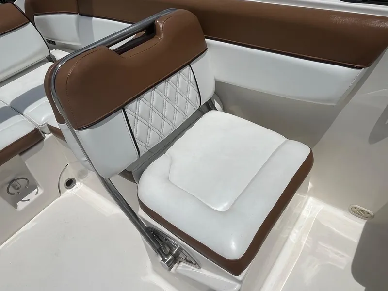 Slide: The Image of Brown and white seat on 2022 Bayliner DX 2200 boat interior. - 7