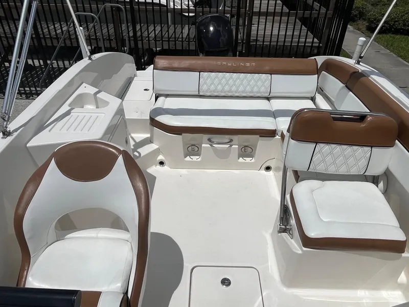 Slide: The Image of 2022 Bayliner DX 2200 boat interior with white and brown seating. - 9