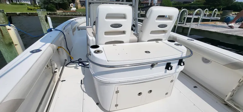 Slide: The Image of 2004 Boston Whaler 320 Outrage boat interior with seating and storage compartments. - 10