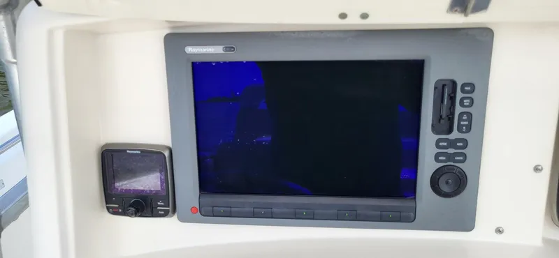 Slide: The Image of Control panel of a 2004 Boston Whaler 320 Outrage with Raymarine electronics. - 11