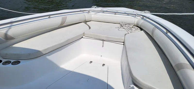 Slide: The Image of 2004 Boston Whaler 320 Outrage boat interior with white seating and railing. - 13
