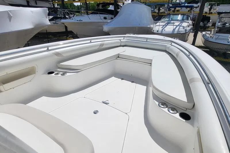 Slide: The Image of 2004 Boston Whaler 320 Outrage boat interior with white seating and cup holders. - 14