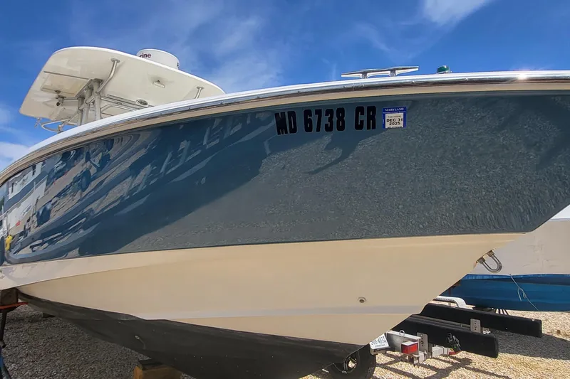 Slide: The Image of 2004 Boston Whaler 320 Outrage boat on trailer, clear sky background. - 1
