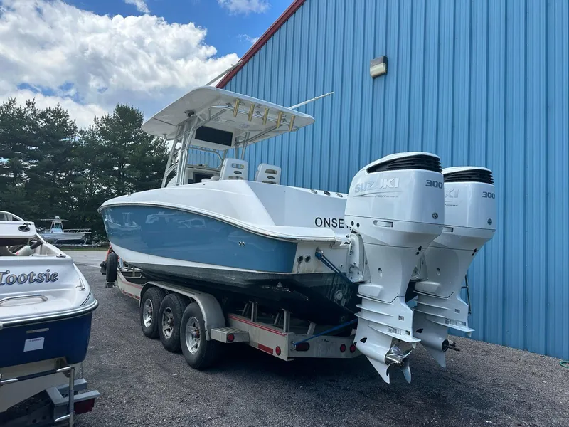 Slide: The Image of 2004 Boston Whaler 320 Outrage boat with twin Suzuki 300 engines on a trailer. - 2