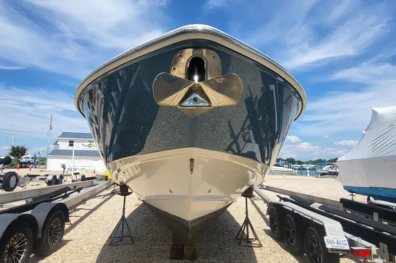 Slide: The Image of 2004 Boston Whaler 320 Outrage boat on trailer, displayed outdoors under a clear blue sky. - 5