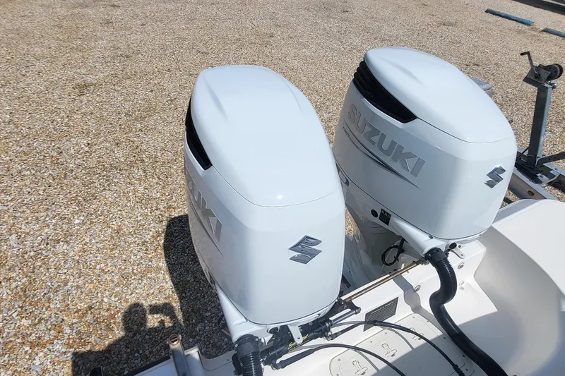 Slide: The Image of Twin Suzuki outboard engines on a 2004 Boston Whaler 320 Outrage boat. - 19