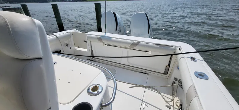 Slide: The Image of 2004 Boston Whaler 320 Outrage boat interior with seating and water view. - 6