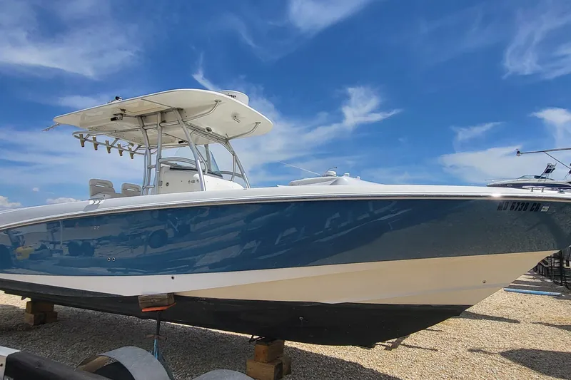 The Image of 2004 Boston Whaler 320 Outrage boat on display under a clear blue sky. - 0