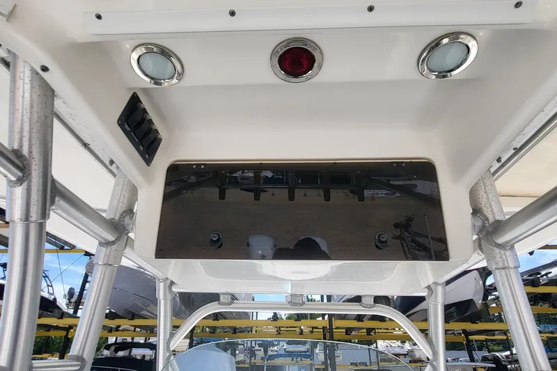 Slide: The Image of 2004 Boston Whaler 320 Outrage boat console with overhead storage and lighting. - 11