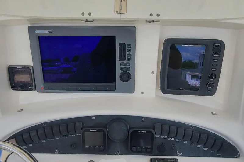 Slide: The Image of Dashboard of a 2004 Boston Whaler 320 Outrage with navigation and control panels. - 10