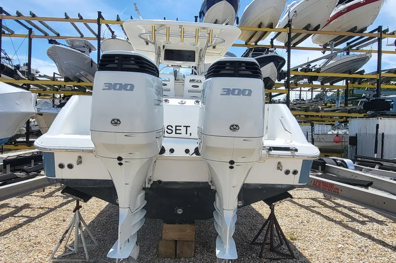 Slide: The Image of 2004 Boston Whaler 320 Outrage with twin 300 horsepower engines in a boatyard. - 9
