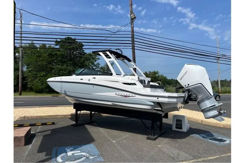 Slide: The Image of 2026 Monterey M-45 boat displayed on a stand outdoors, featuring a sleek design. - 1