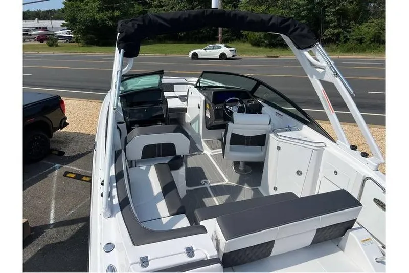 Slide: The Image of 2026 Monterey M-45 boat interior with seating and steering wheel, parked near a road. - 18