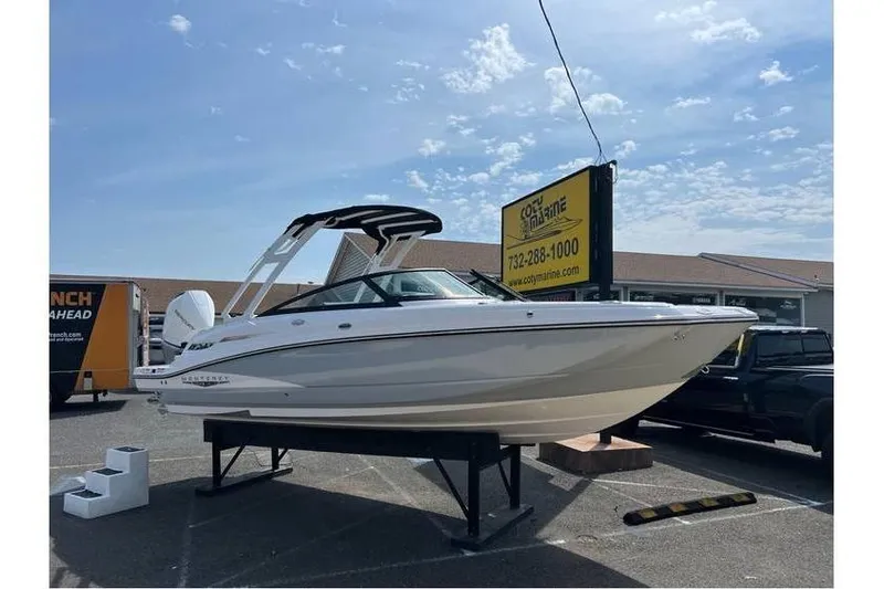 Slide: The Image of 2026 Monterey M-45 boat displayed outdoors on a stand under a clear sky. - 2