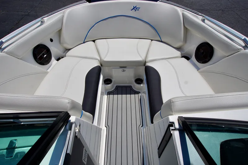 Slide: The Image of 2018 MasterCraft XT22 boat interior with white seating and speakers. - 11