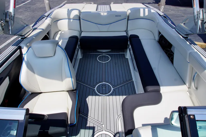 Slide: The Image of 2018 MasterCraft XT22 boat interior with white and black seating, modern design. - 12