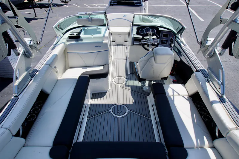 Slide: The Image of 2018 MasterCraft XT22 boat interior with sleek seating and modern dashboard. - 7