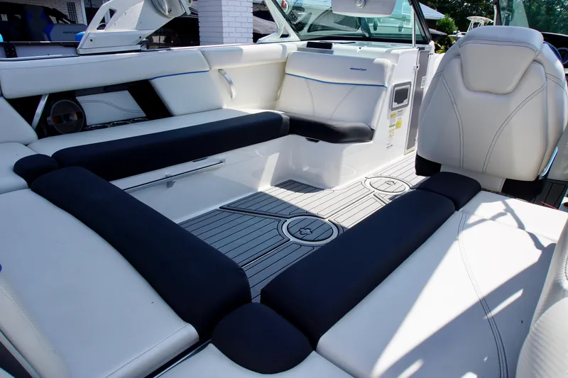 Slide: The Image of 2018 MasterCraft XT22 boat interior with white and black seating, modern design. - 8