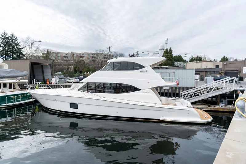Slide: The Image of 2010 Maritimo M56 yacht docked at a marina, showcasing sleek design and modern features. - 1