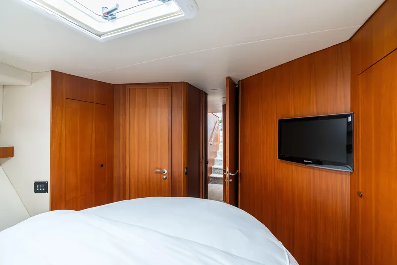 Slide: The Image of Luxurious cabin interior of 2010 Maritimo M56 yacht with wood paneling and TV. - 11