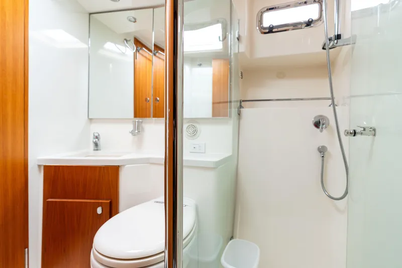 Slide: The Image of Luxurious bathroom in 2010 Maritimo M56 yacht with modern fixtures and wood accents. - 12