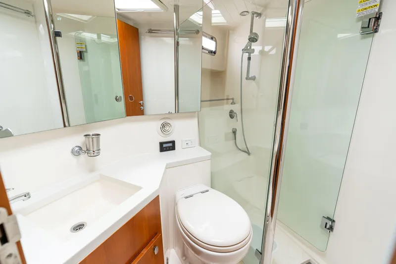 Slide: The Image of Luxurious bathroom in 2010 Maritimo M56 yacht with modern fixtures and glass shower. - 14