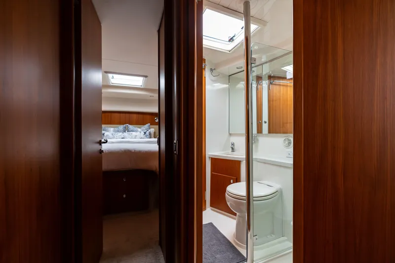 Slide: The Image of Luxurious interior of 2010 Maritimo M56 yacht featuring bedroom and bathroom. - 15