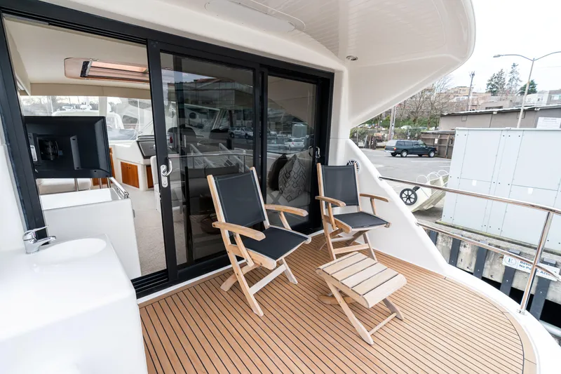 Slide: The Image of Deck of 2010 Maritimo M56 yacht with chairs and table, docked at marina. - 20