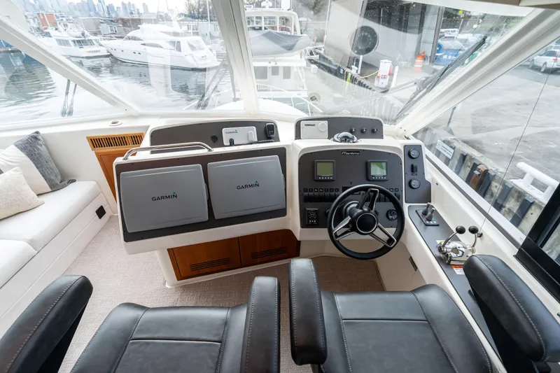 Slide: The Image of Cockpit of 2010 Maritimo M56 yacht with Garmin navigation systems and leather seating. - 22