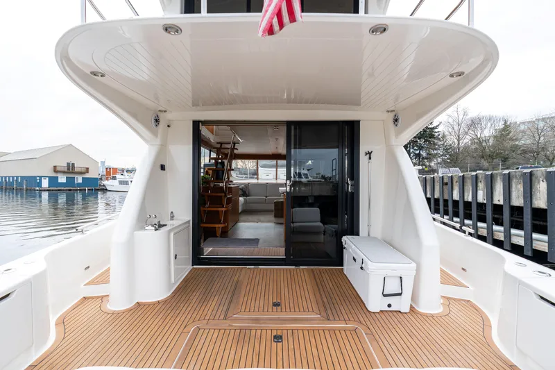 Slide: The Image of Luxury Maritimo M56 yacht deck with teak flooring and spacious interior view, 2010 model. - 24