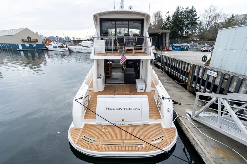 Slide: The Image of 2010 Maritimo M56 yacht docked at marina, rear view with wooden deck. - 27
