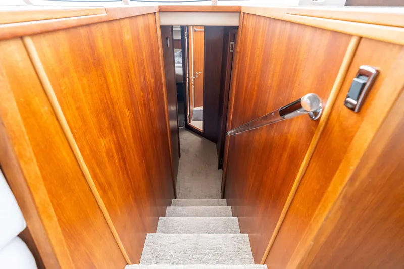 Slide: The Image of Staircase with wooden paneling inside a 2010 Maritimo M56 yacht. - 7