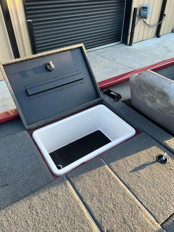 Slide: The Image of Open storage compartment on 2024 Avid 20 XB boat, featuring a spacious interior. - 14