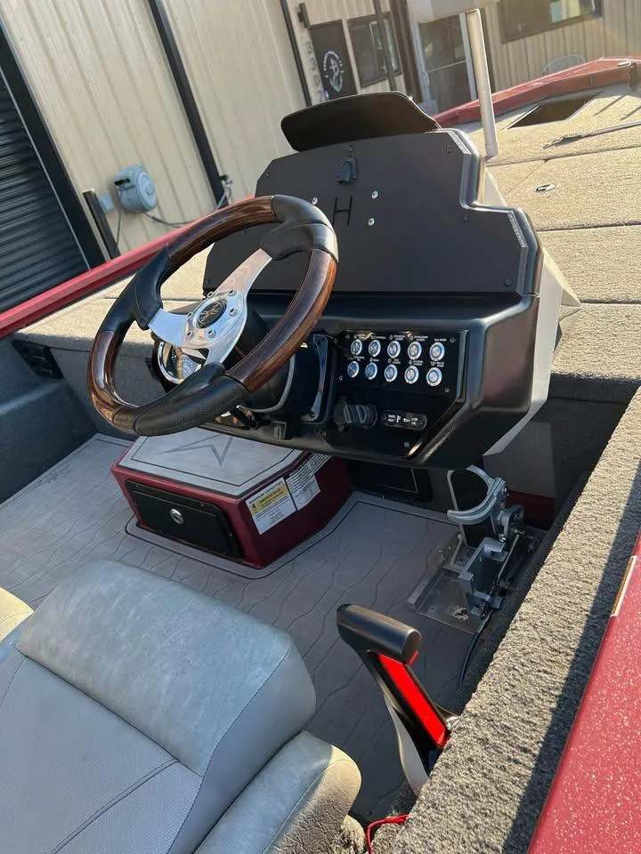 Slide: The Image of 2024 Avid 20 XB boat cockpit with steering wheel and control panel. - 17