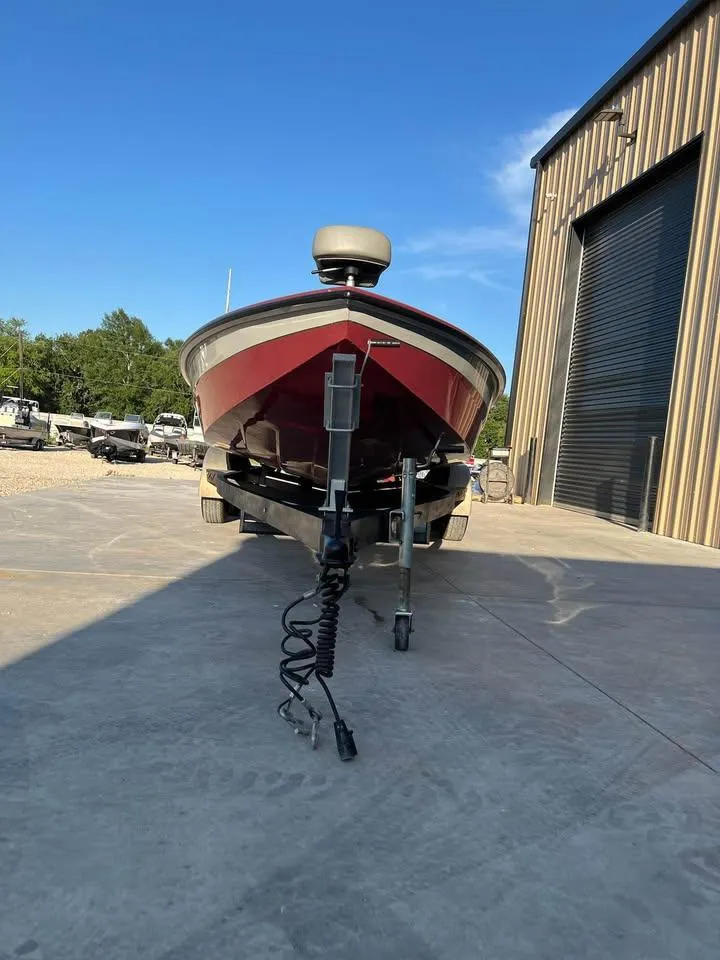 Slide: The Image of 2024 Avid 20 XB boat on trailer outside a warehouse. - 7