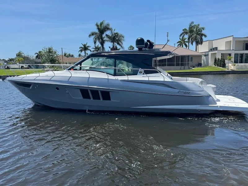 Slide: The Image of 2014 Cruisers Yachts 45 Cantius Black Diamond on water, sleek design, sunny day. - 0