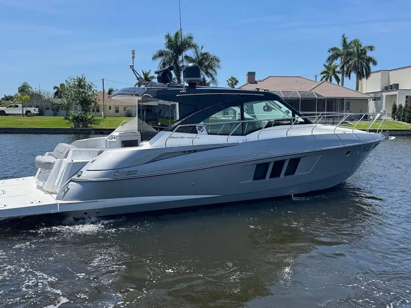 Slide: The Image of 2014 Cruisers Yachts 45 Cantius Black Diamond on water near waterfront homes. - 11