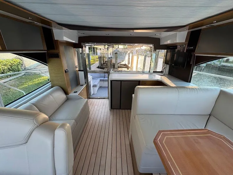 Slide: The Image of Interior of 2014 Cruisers Yachts 45 Cantius Black Diamond with elegant seating and wooden flooring. - 17