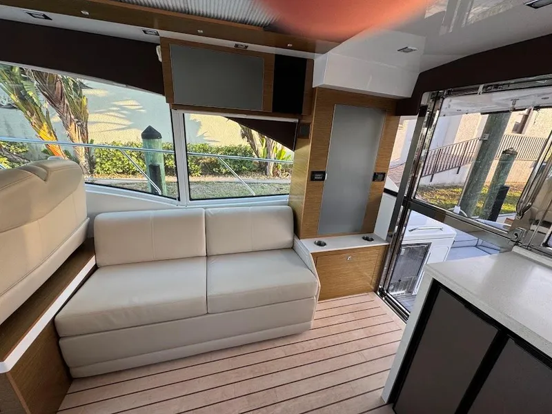 Slide: The Image of Interior of 2014 Cruisers Yachts 45 Cantius Black Diamond with modern seating and large windows. - 18