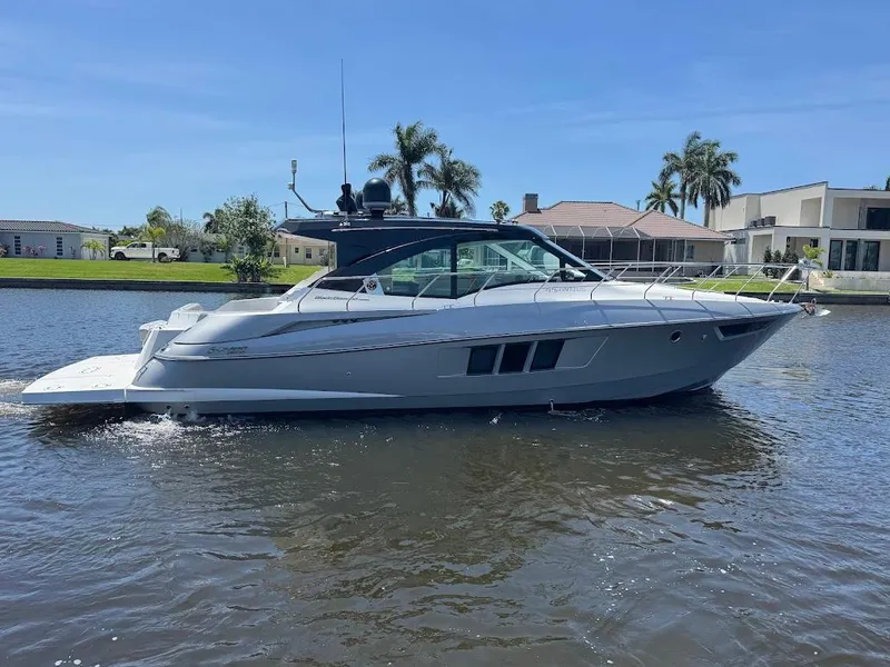 Slide: The Image of 2014 Cruisers Yachts 45 Cantius Black Diamond on a sunny waterfront. - 2