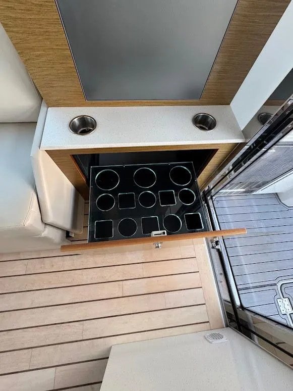 Slide: The Image of 2014 Cruisers Yachts 45 Cantius Black Diamond interior with cup holders and storage drawer. - 21