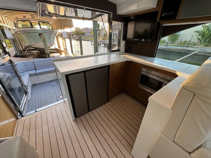 Slide: The Image of 2014 Cruisers Yachts 45 Cantius Black Diamond interior with modern kitchen and seating area. - 23