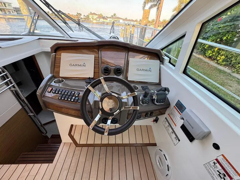 Slide: The Image of Helm of 2014 Cruisers Yachts 45 Cantius Black Diamond with Garmin displays and modern controls. - 26