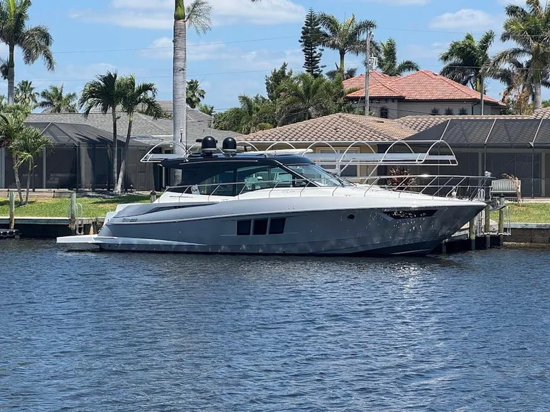 Slide: The Image of 2014 Cruisers Yachts 45 Cantius Black Diamond docked by waterfront homes. - 3