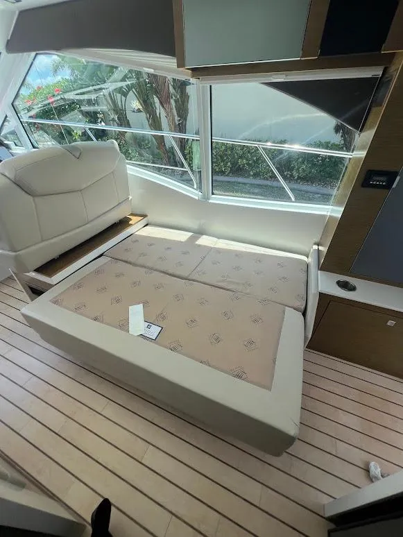 Slide: The Image of 2014 Cruisers Yachts 45 Cantius Black Diamond interior with convertible seating and large windows. - 31