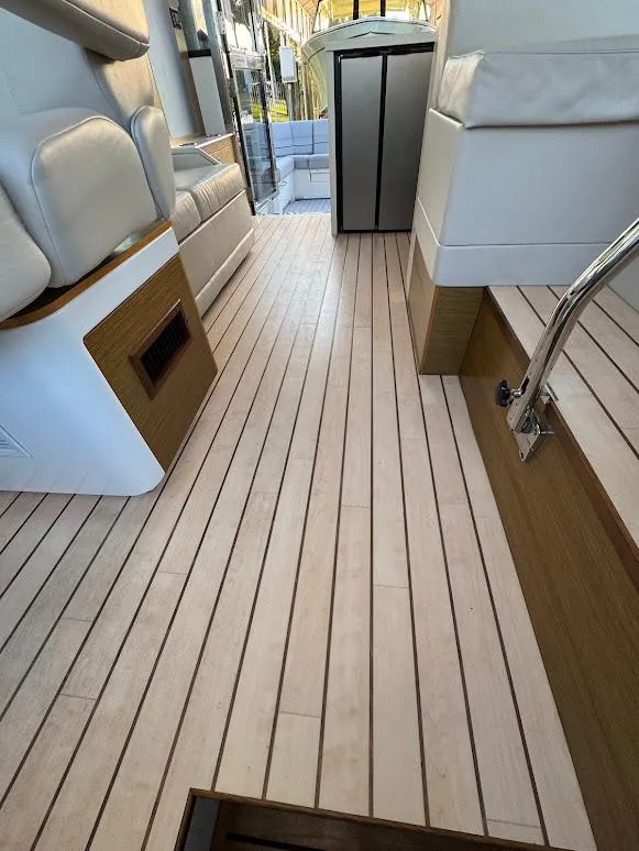 Slide: The Image of 2014 Cruisers Yachts 45 Cantius Black Diamond interior with sleek wood flooring and modern seating. - 36
