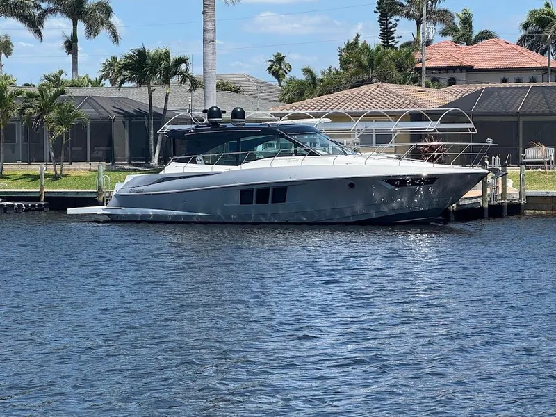 Slide: The Image of 2014 Cruisers Yachts 45 Cantius Black Diamond docked by waterfront homes. - 4
