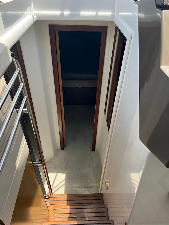 Slide: The Image of Stairway leading to cabin interior of 2014 Cruisers Yachts 45 Cantius Black Diamond. - 41